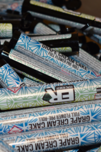 An image of multiple ER Pre-Roll containers to show off packaging. Each labeled "grape cream cake"