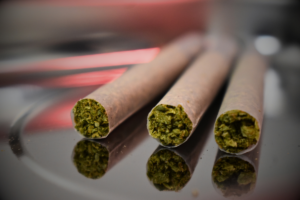 An up-close shot of three pre-rolled joints and the highly detailed visual of the flower in each. 